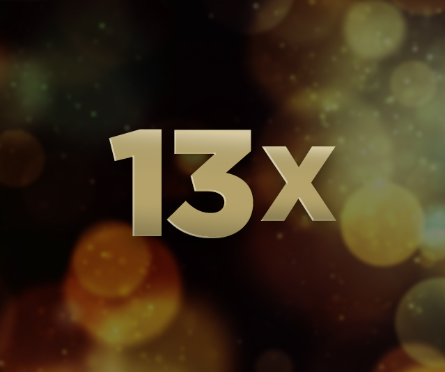 '13X' in the middle of a black background with yellow lights in the distance