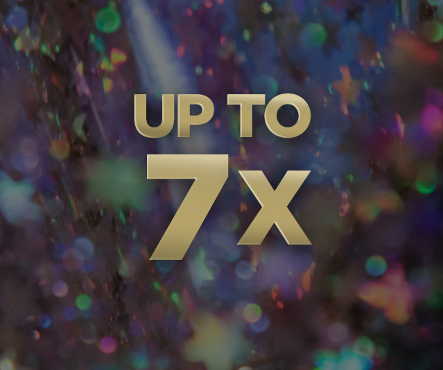 'Up to 7X' in the middle of blurry colourful lights background